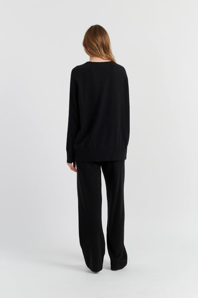 Person wearing a black outfit on a white background