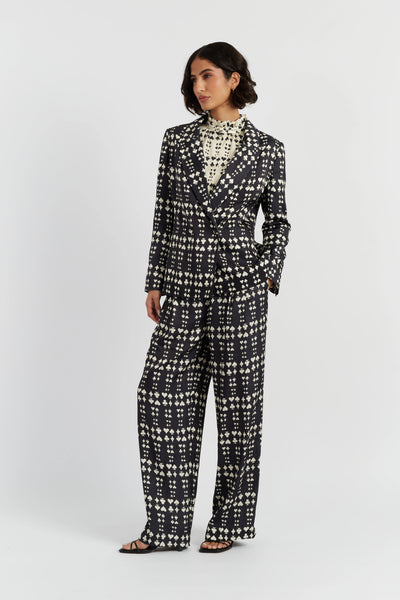 Woman wearing a black and white patterned suit on a white background