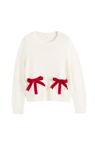 White sweater with red bows on a white background