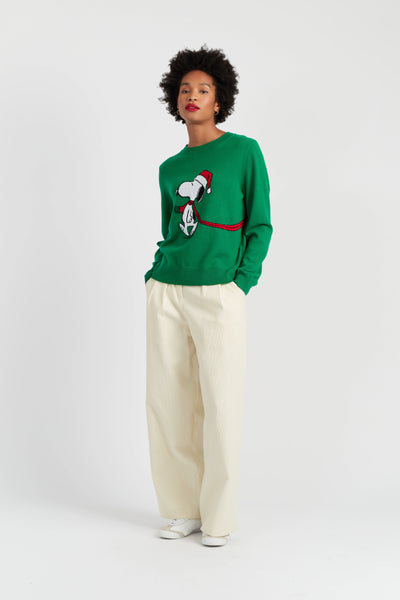 Person wearing a green sweater with a graphic design on a white background