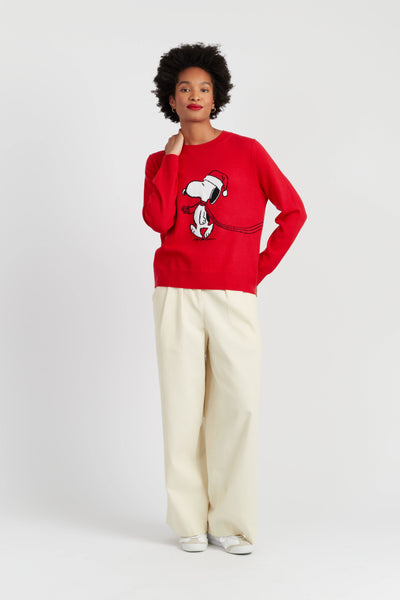Person wearing a red sweater with a graphic design on a white background