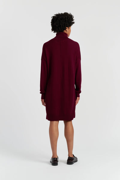 Person wearing a burgundy dress on a white background