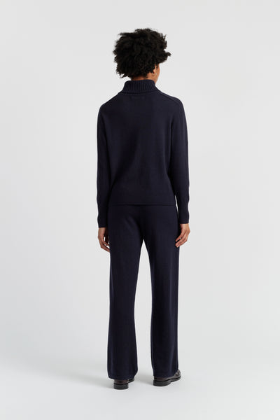 Person wearing a black outfit on a white background