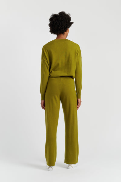 Person wearing a green outfit on a white background