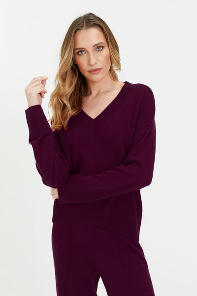 Woman wearing a purple outfit on a white background