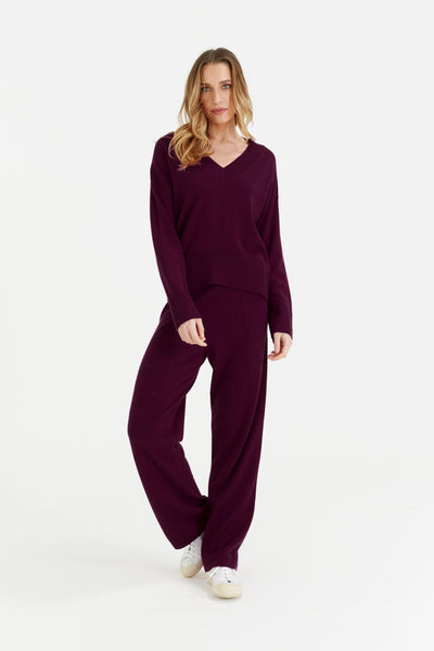 Woman wearing a purple outfit on a white background