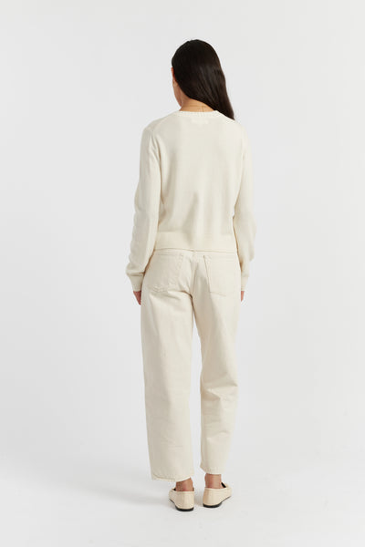 Person wearing a beige outfit on a white background