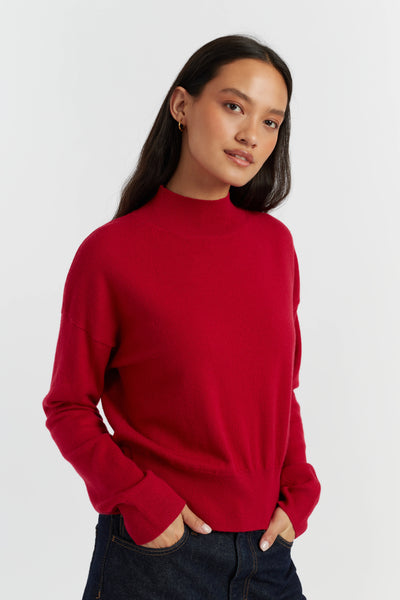 Person wearing a red sweater on a white background