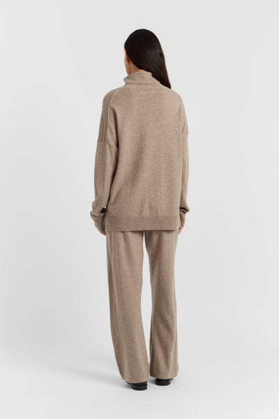Woman wearing a beige suit on a white background