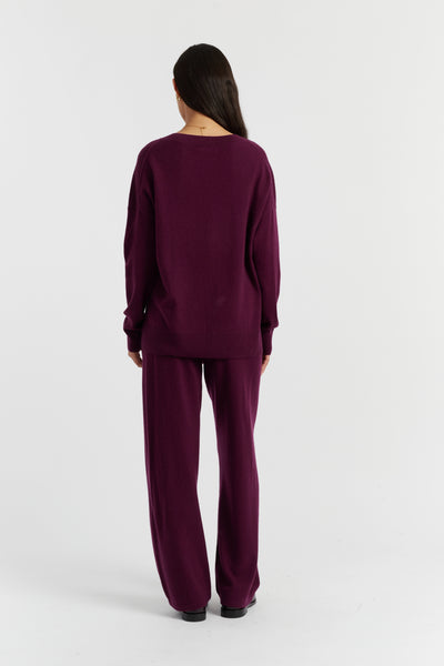 Person wearing a purple outfit on a white background