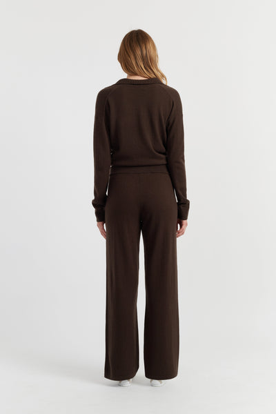 Woman wearing a brown outfit on a white background