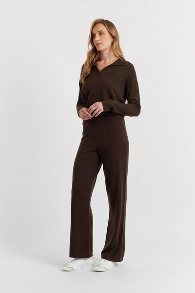 Woman wearing a brown outfit on a white background