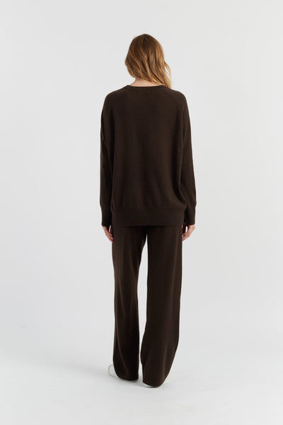 Person wearing a brown outfit on a white background