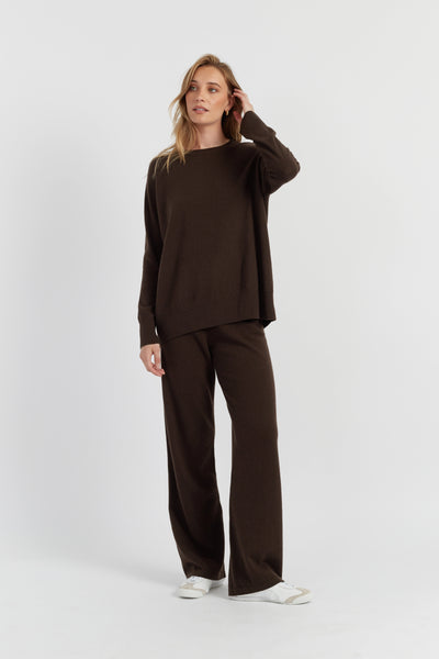 Woman wearing a brown outfit on a white background