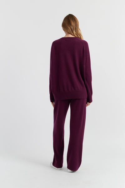 Person wearing a purple outfit on a white background