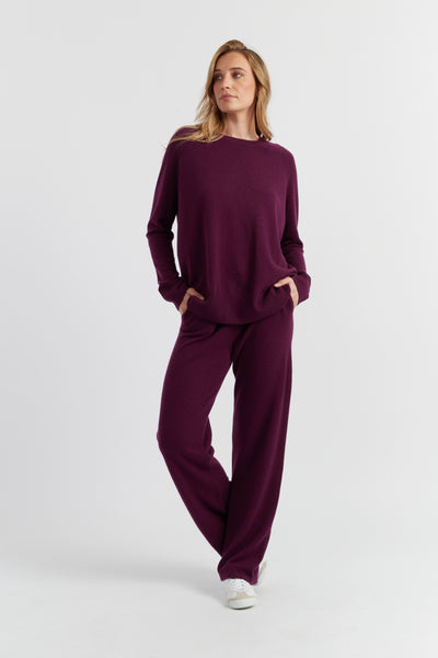 Woman wearing a burgundy outfit on a white background