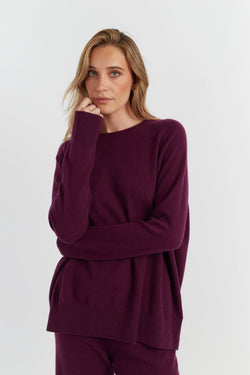 Woman wearing a burgundy outfit against a white background