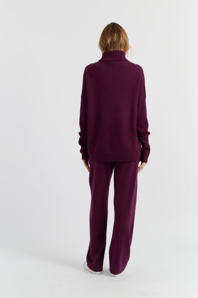Person wearing a purple outfit on a white background