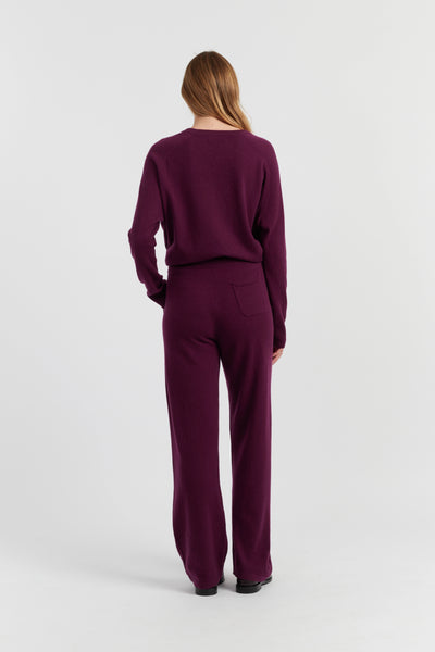 Person wearing a purple outfit on a white background