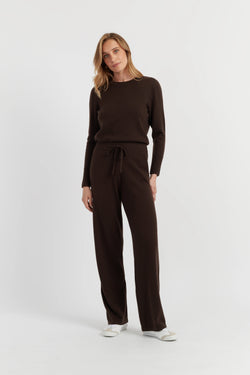 Woman wearing a brown outfit on a white background