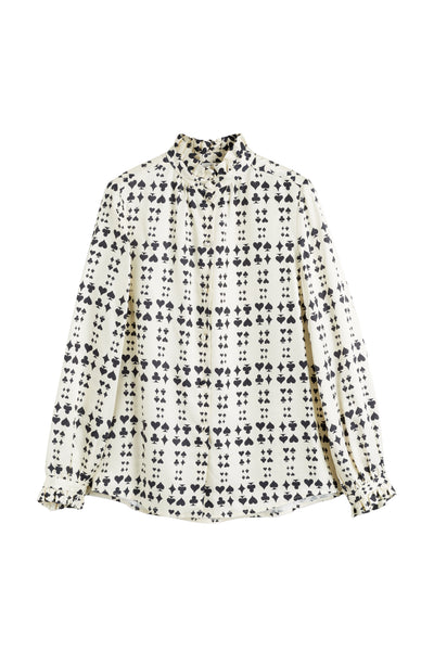 White blouse with black floral pattern on a white background