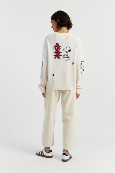 Person wearing a white outfit with cartoon character designs on a plain background