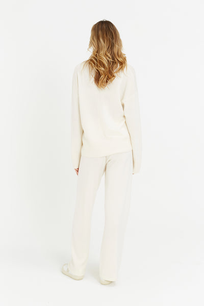 Person wearing a white outfit on a white background