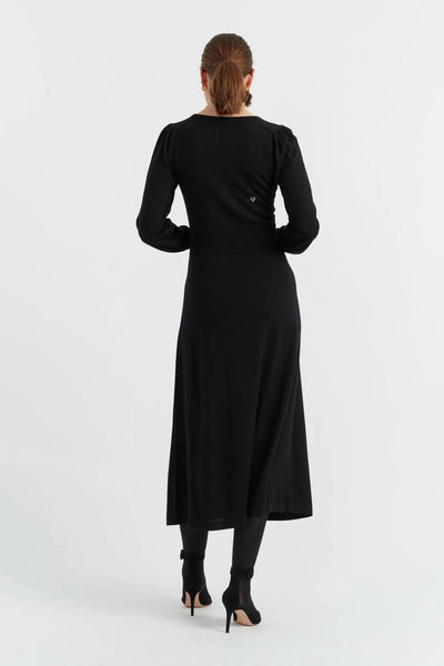 Black dress worn by a person on a white background