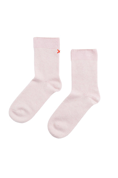 Pair of light pink socks on a white background