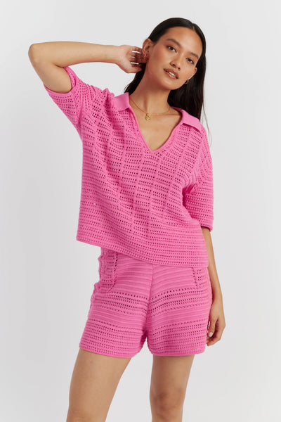 Woman wearing a pink crochet outfit on a white background