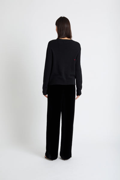 Person wearing a black outfit on a white background