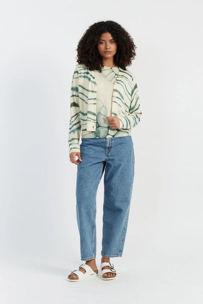 Woman wearing a striped shirt and blue jeans on a white background