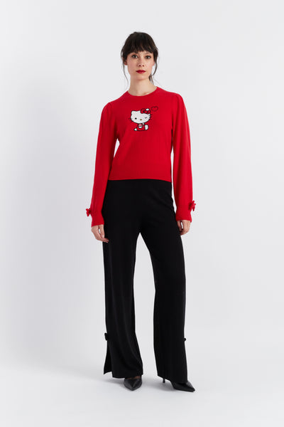 Person wearing a red sweater with a graphic design on a white background