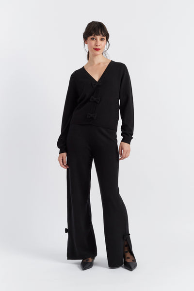 Woman wearing a black outfit on a white background