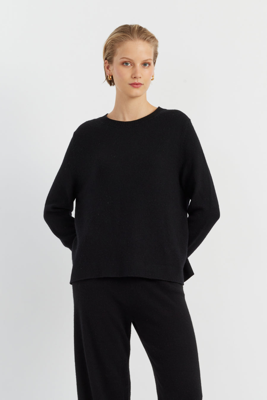 Woman wearing a black outfit on a white background