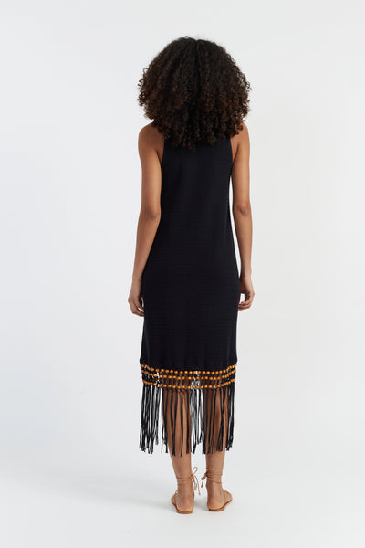 Black dress with fringe details on a white background