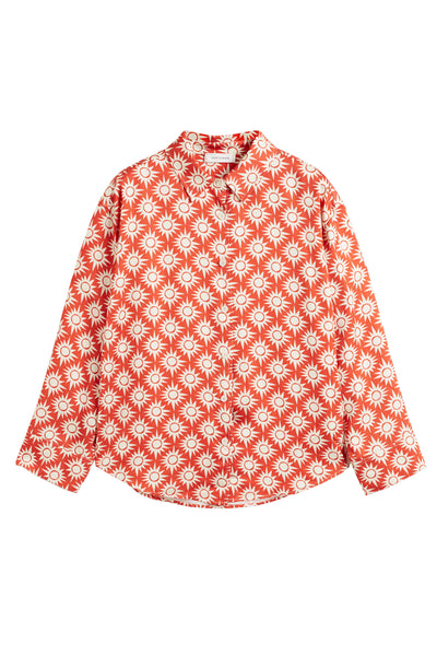 Red blouse with white floral pattern on a white background
