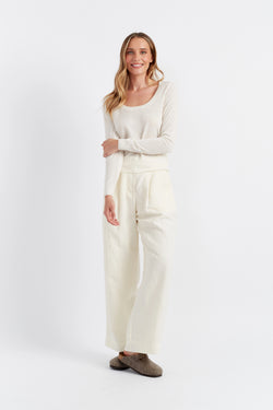 Woman wearing a white outfit on a white background