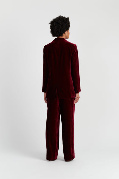 Person wearing a burgundy suit on a white background