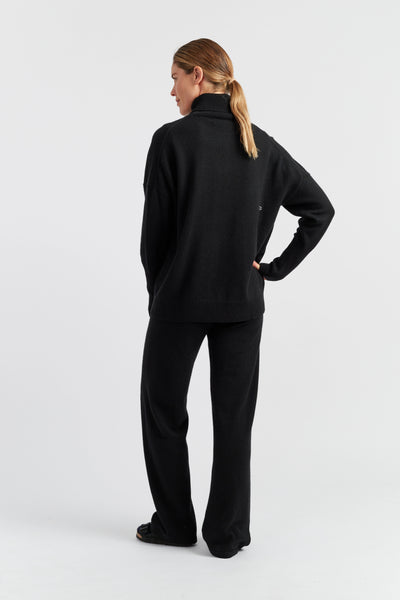 Woman wearing a black outfit on a white background