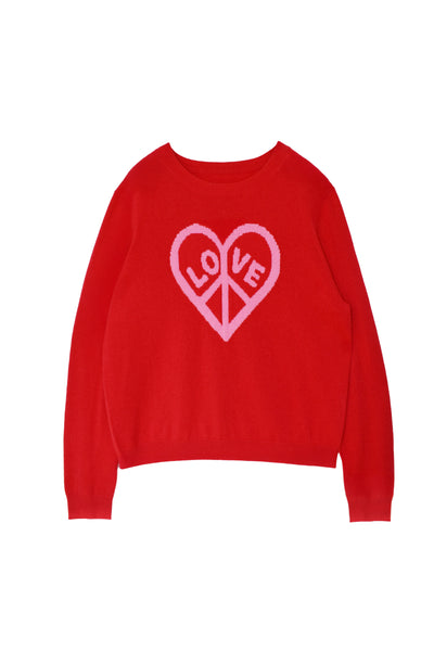 Person wearing a red sweater with a heart design and pink pants on a white background