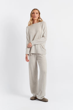 Woman wearing a beige outfit on a white background