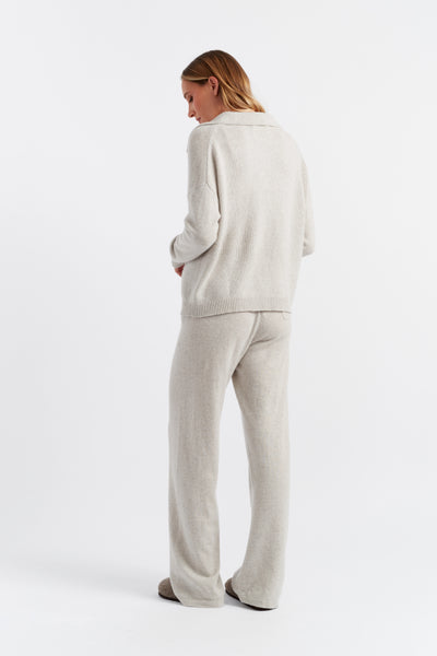 Woman wearing a light gray outfit on a white background