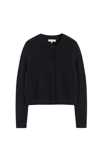 Woman wearing a black cardigan and black pants on a white background