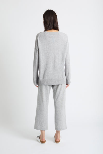 Woman wearing a grey outfit on a white background