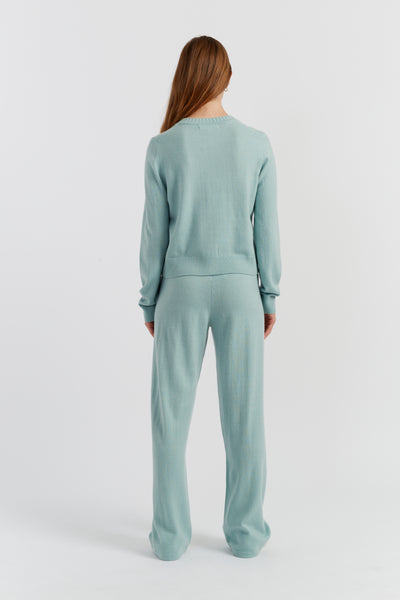 Person wearing a light blue set on a white background