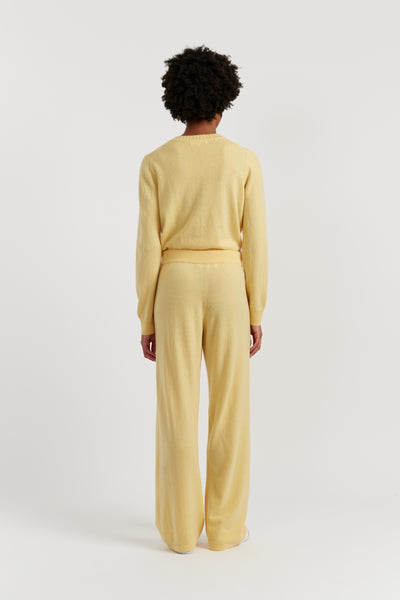 Person wearing a yellow outfit on a white background