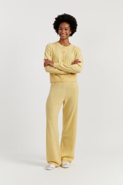Person wearing a yellow outfit on a white background