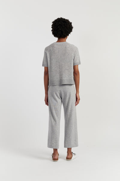 Person wearing a grey outfit on a white background