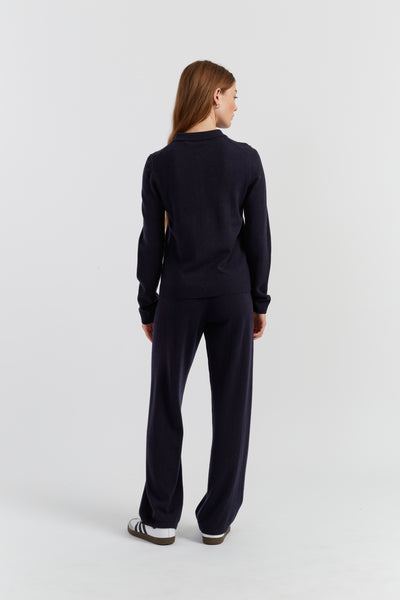 Person wearing a navy blue outfit on a white background